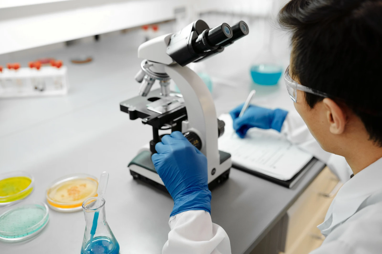 A researcher examining a sample with a microscope.