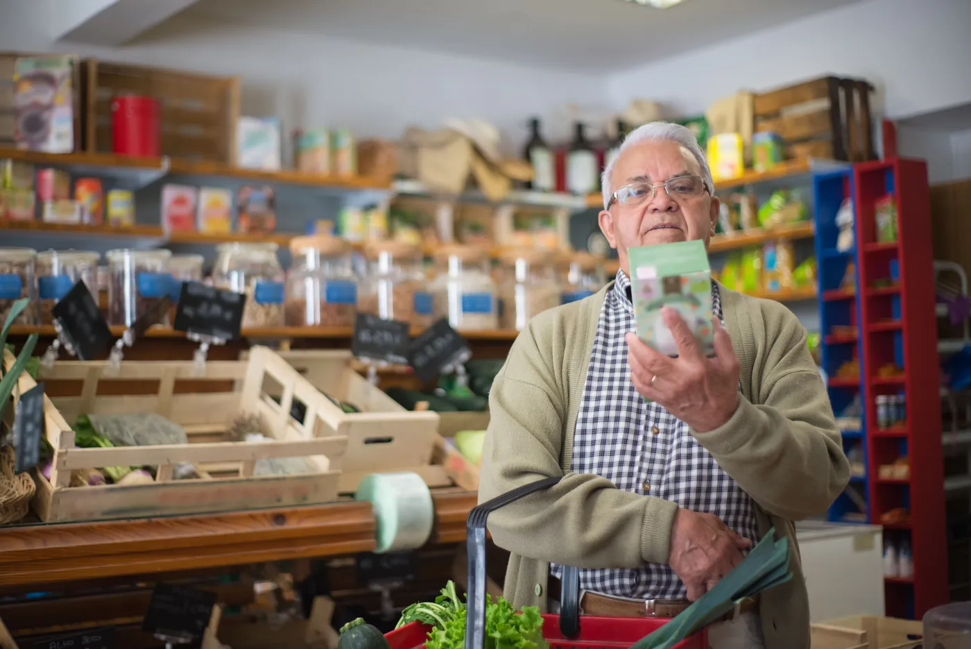 A shopper examining a product label in a food shop.