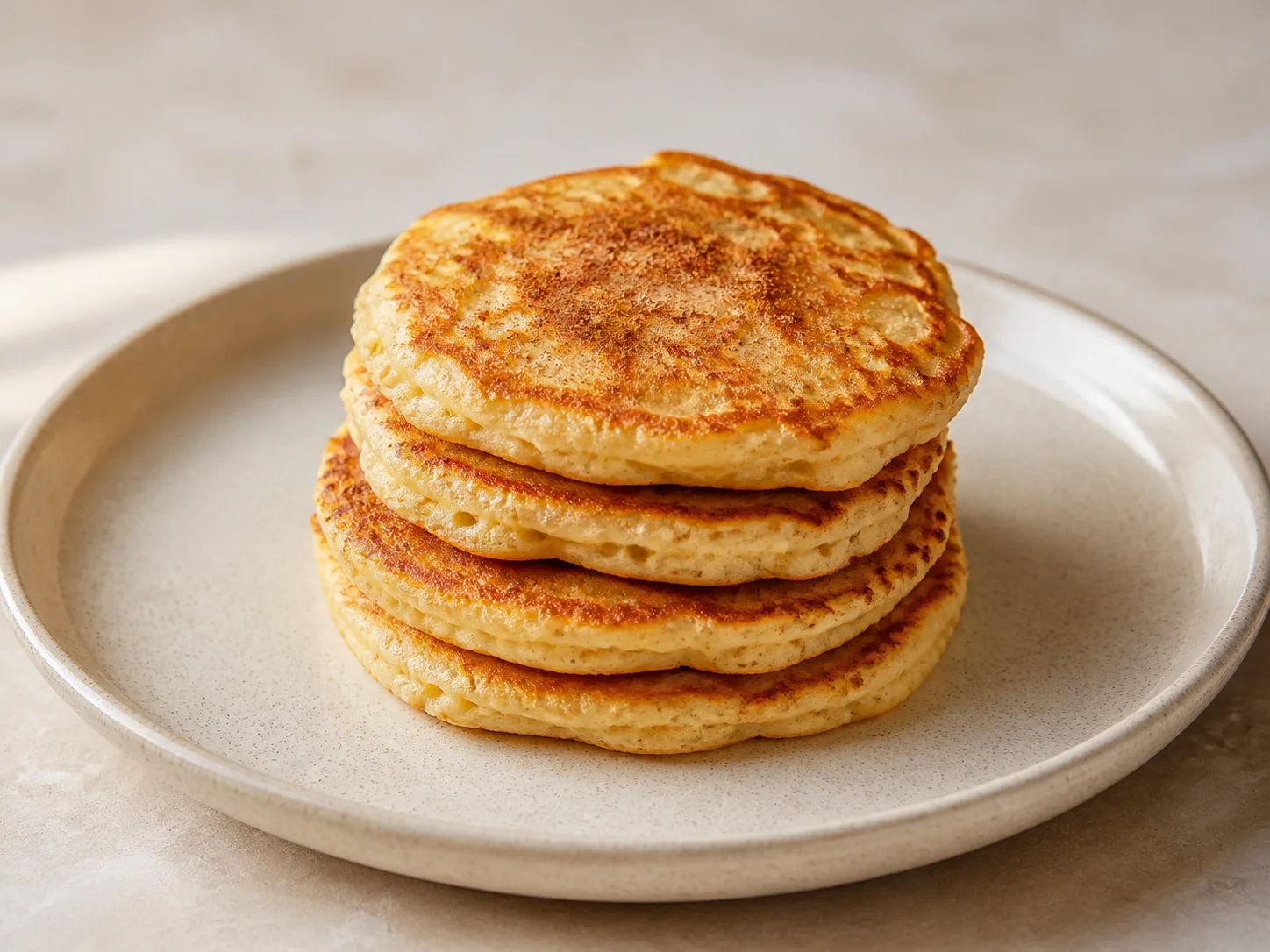 A stack of golden apple and cinnamon kefir pancakes.
