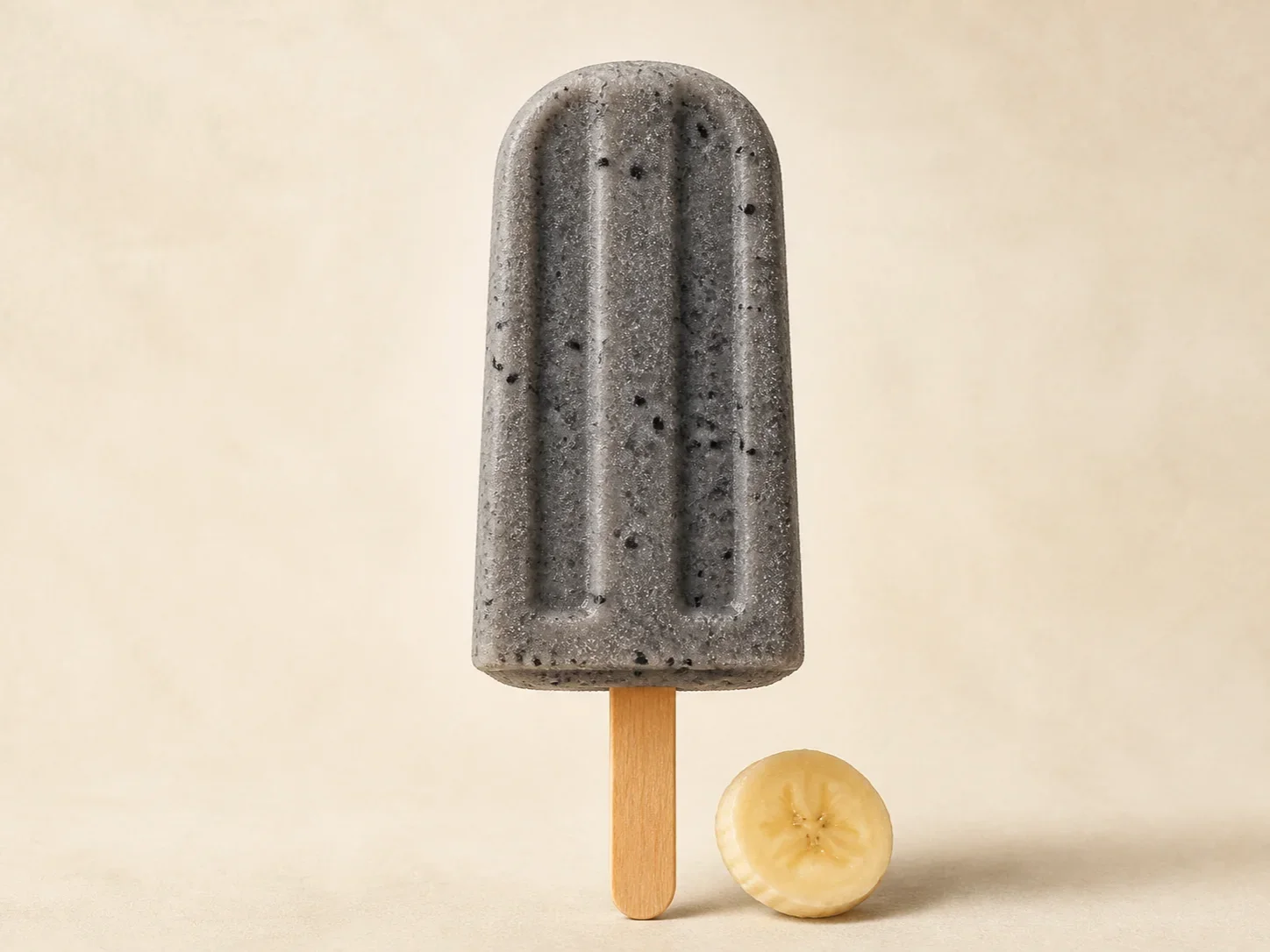 A finished serving of black sesame banana kefir ice pops
